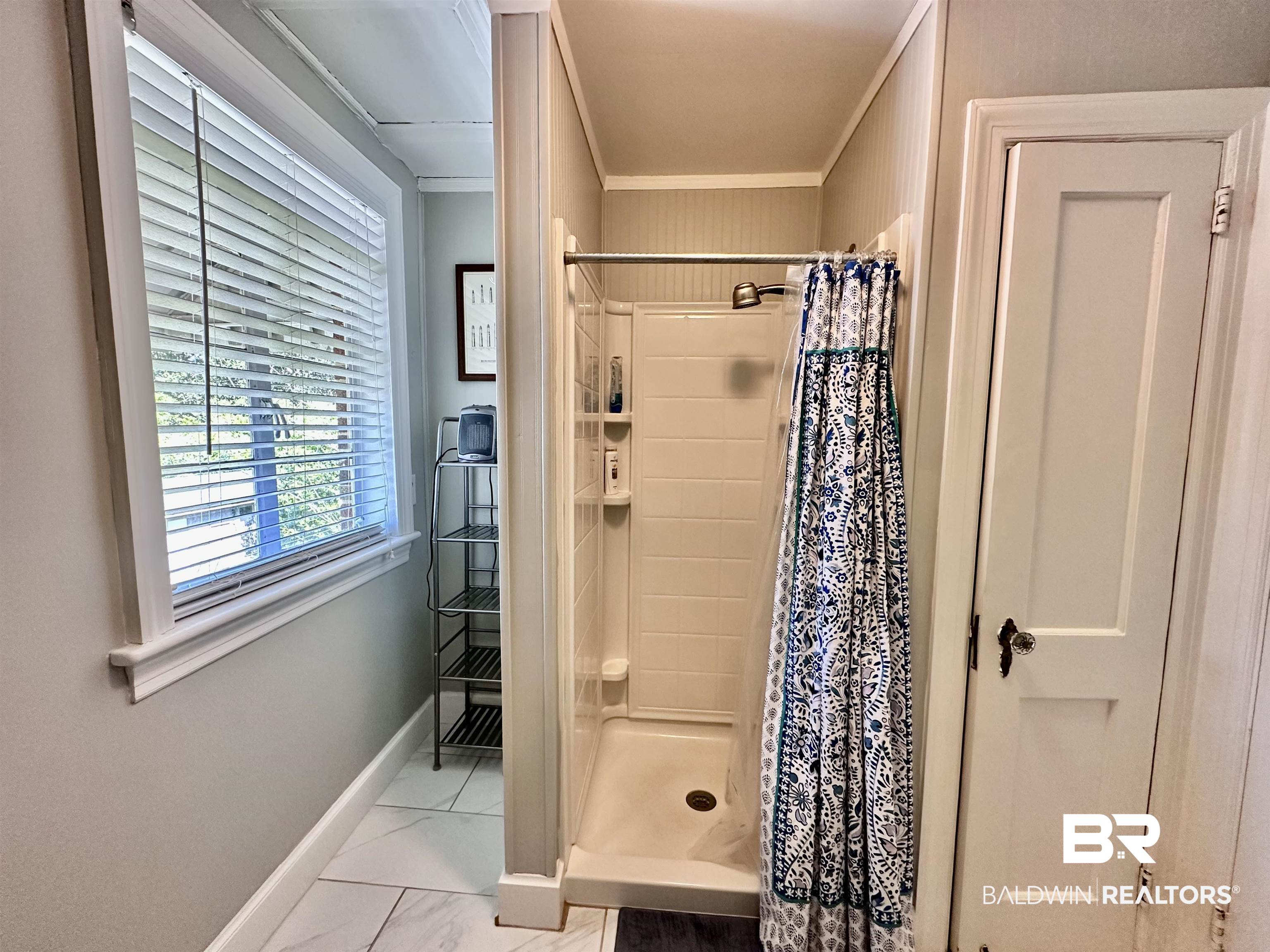 260 Siena Vista Street Mobile, AL 36607 - Photo 31 of 41 Full bathroom with baseboards, a shower stall, marble look tiles, and crown molding