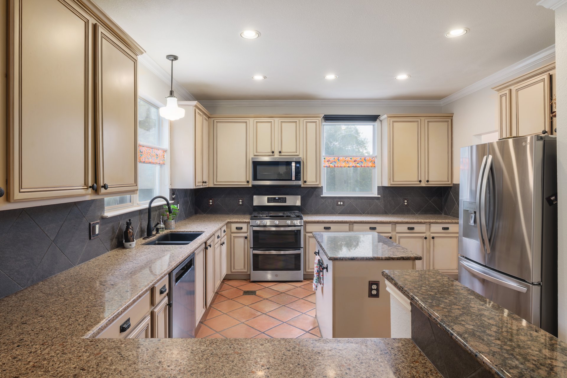 7000 Bending Oak Road Austin, TX 78749 - Photo 7 of 39 a kitchen with stainless steel appliances granite countertop a sink stove and refrigerator