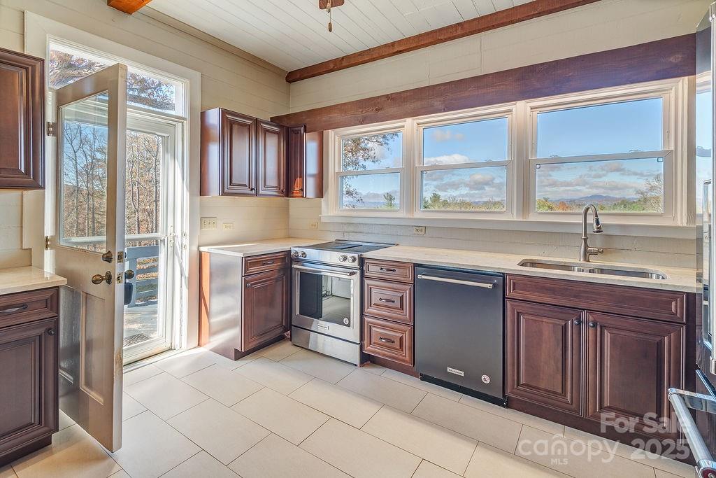 839 Jupiter Road Weaverville, NC 28787 - Photo 11 of 43 a kitchen with stainless steel appliances granite countertop a stove a sink and a refrigerator