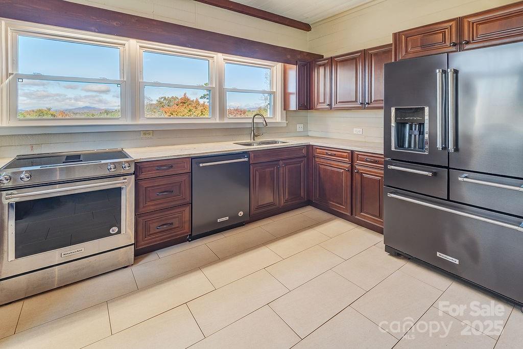 839 Jupiter Road Weaverville, NC 28787 - Photo 12 of 43 a kitchen with stainless steel appliances granite countertop a refrigerator and a stove top oven