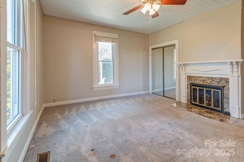 839 Jupiter Road Weaverville, NC 28787 - Photo 15 of 43 an empty room with windows and fireplace