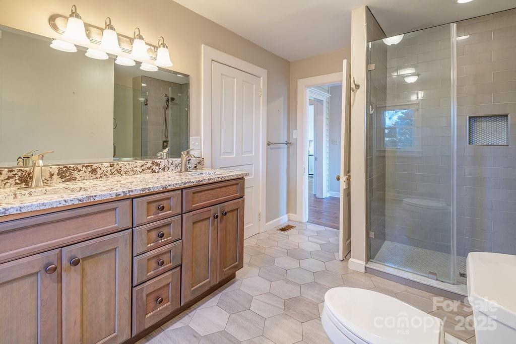 839 Jupiter Road Weaverville, NC 28787 - Photo 16 of 43 a bathroom with a sink a toilet and shower