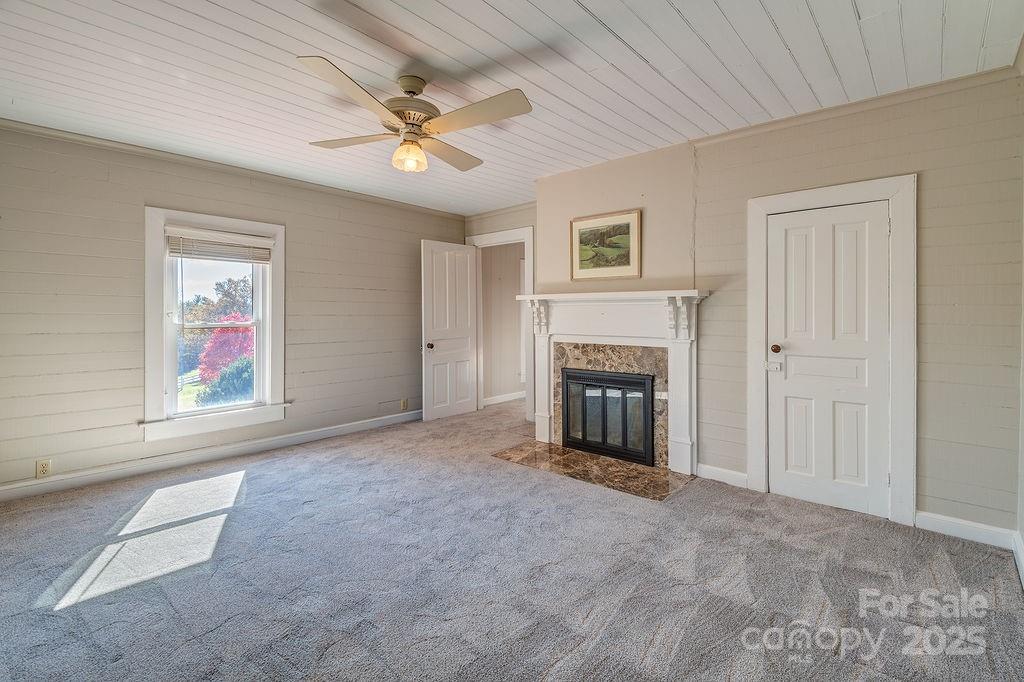 839 Jupiter Road Weaverville, NC 28787 - Photo 17 of 43 an empty room with fireplace and fan