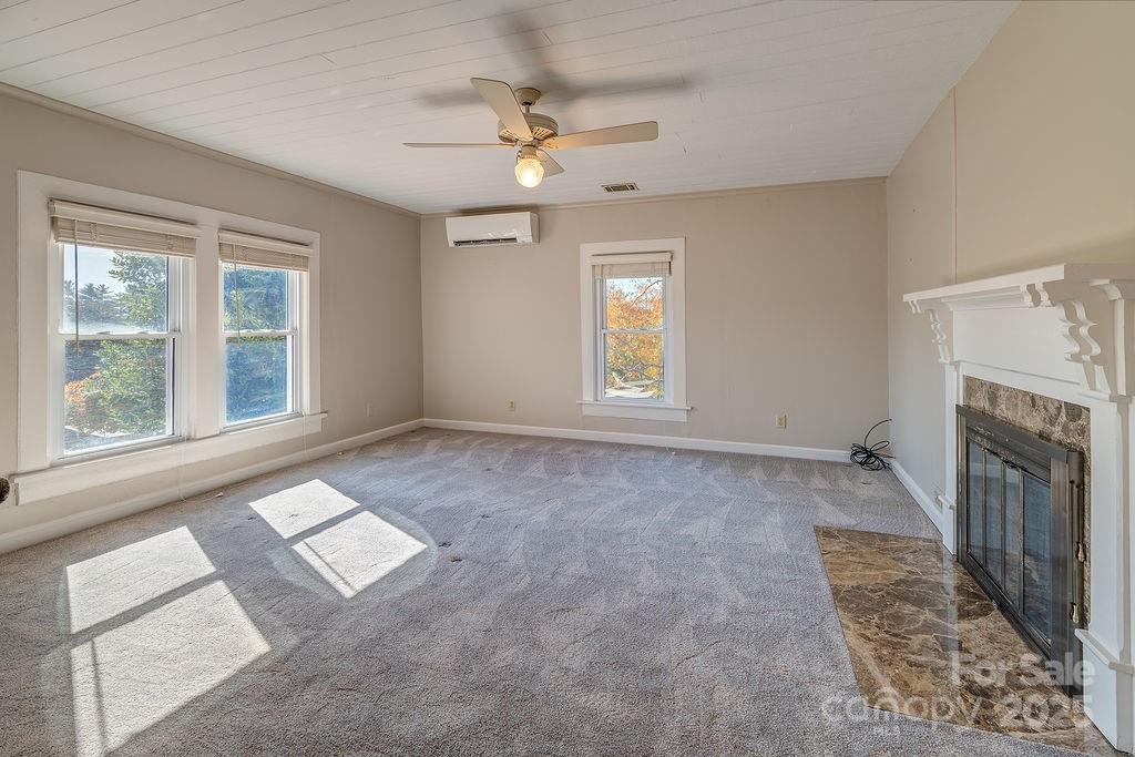 839 Jupiter Road Weaverville, NC 28787 - Photo 18 of 43 an empty room with windows and fireplace