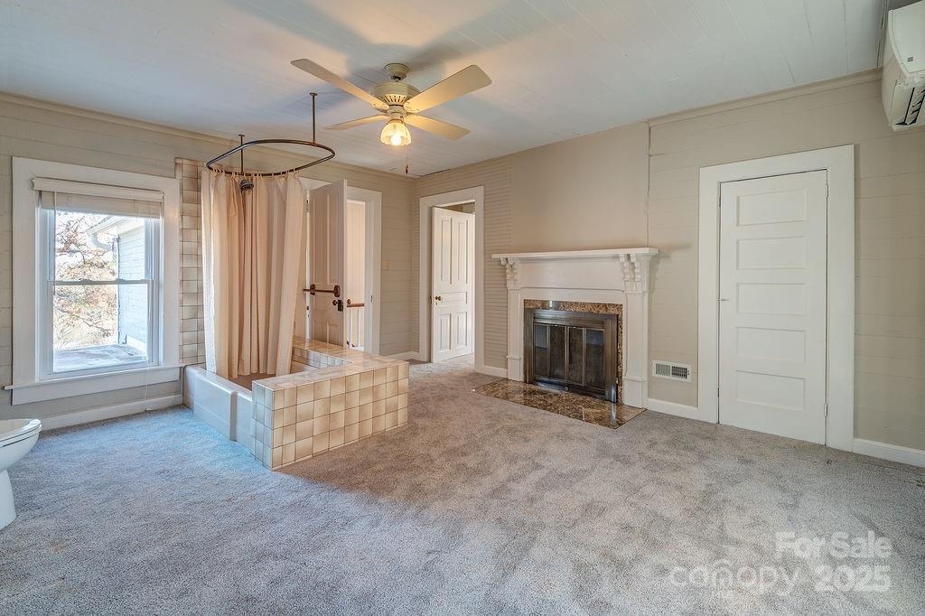 839 Jupiter Road Weaverville, NC 28787 - Photo 19 of 43 an empty room with windows and fireplace