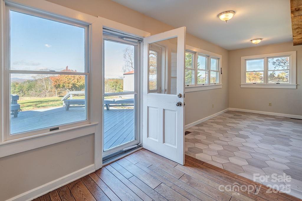 839 Jupiter Road Weaverville, NC 28787 - Photo 20 of 43 a view of an empty room with wooden floor and a window
