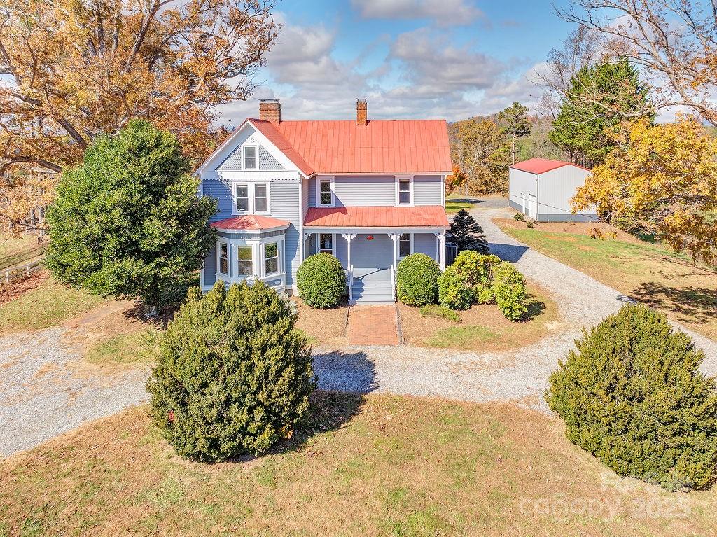 839 Jupiter Road Weaverville, NC 28787 - Photo 33 of 43 a view of a white house with a yard and sitting area