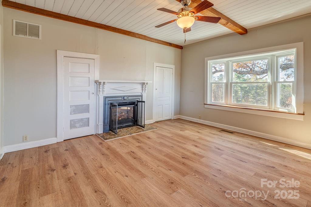 839 Jupiter Road Weaverville, NC 28787 - Photo 8 of 43 an empty room with chandelier fan and windows