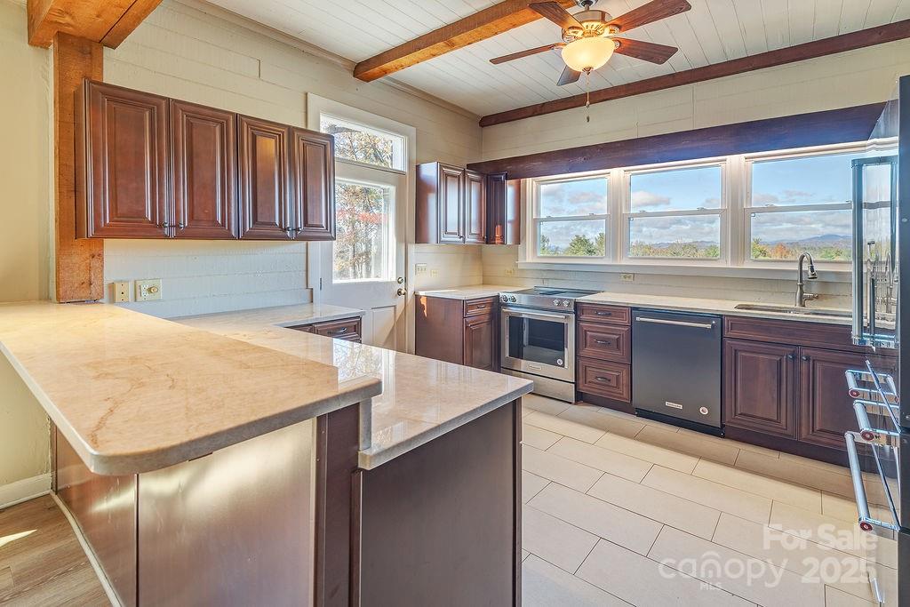 839 Jupiter Road Weaverville, NC 28787 - Photo 10 of 43 a large kitchen with kitchen island a large window a sink and cabinets