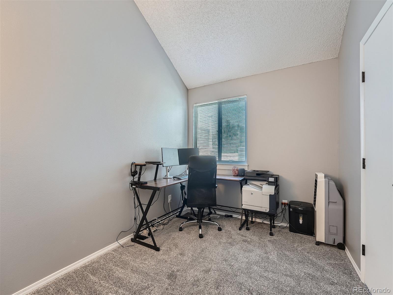 4911 Garrison Street, Unit 202G Wheat Ridge, CO 80033 - Photo 23 of 33 a view of a workspace with furniture and a window