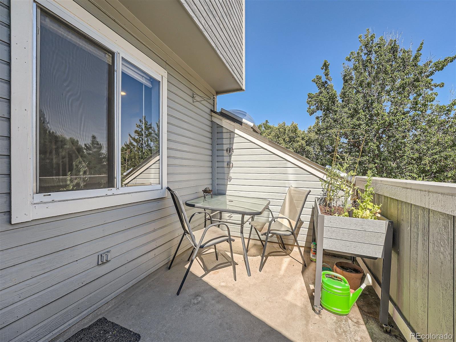 4911 Garrison Street, Unit 202G Wheat Ridge, CO 80033 - Photo 26 of 33 a view of a chairs and table in patio