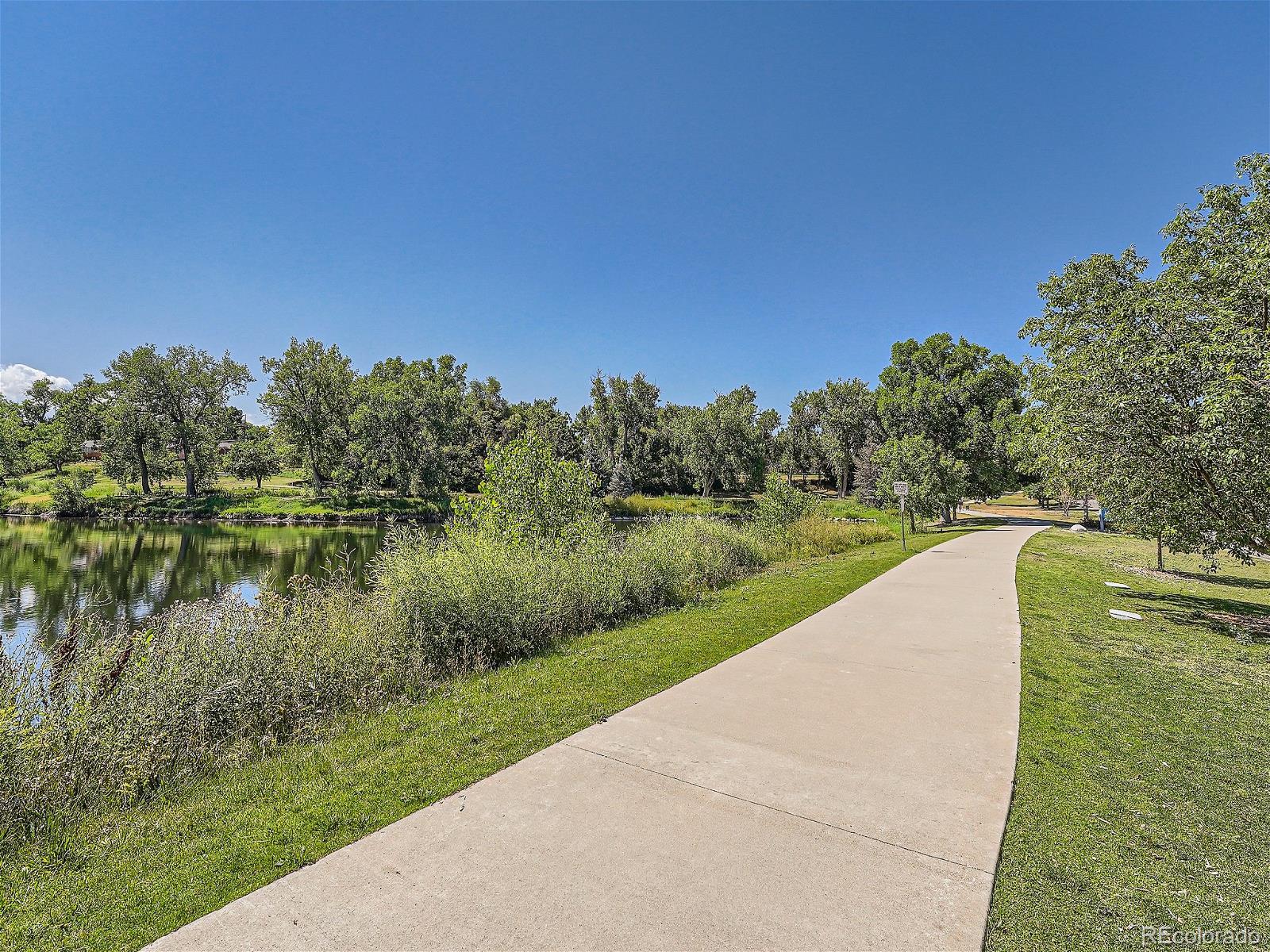 4911 Garrison Street, Unit 202G Wheat Ridge, CO 80033 - Photo 27 of 33 a view of a lake view with a big yard