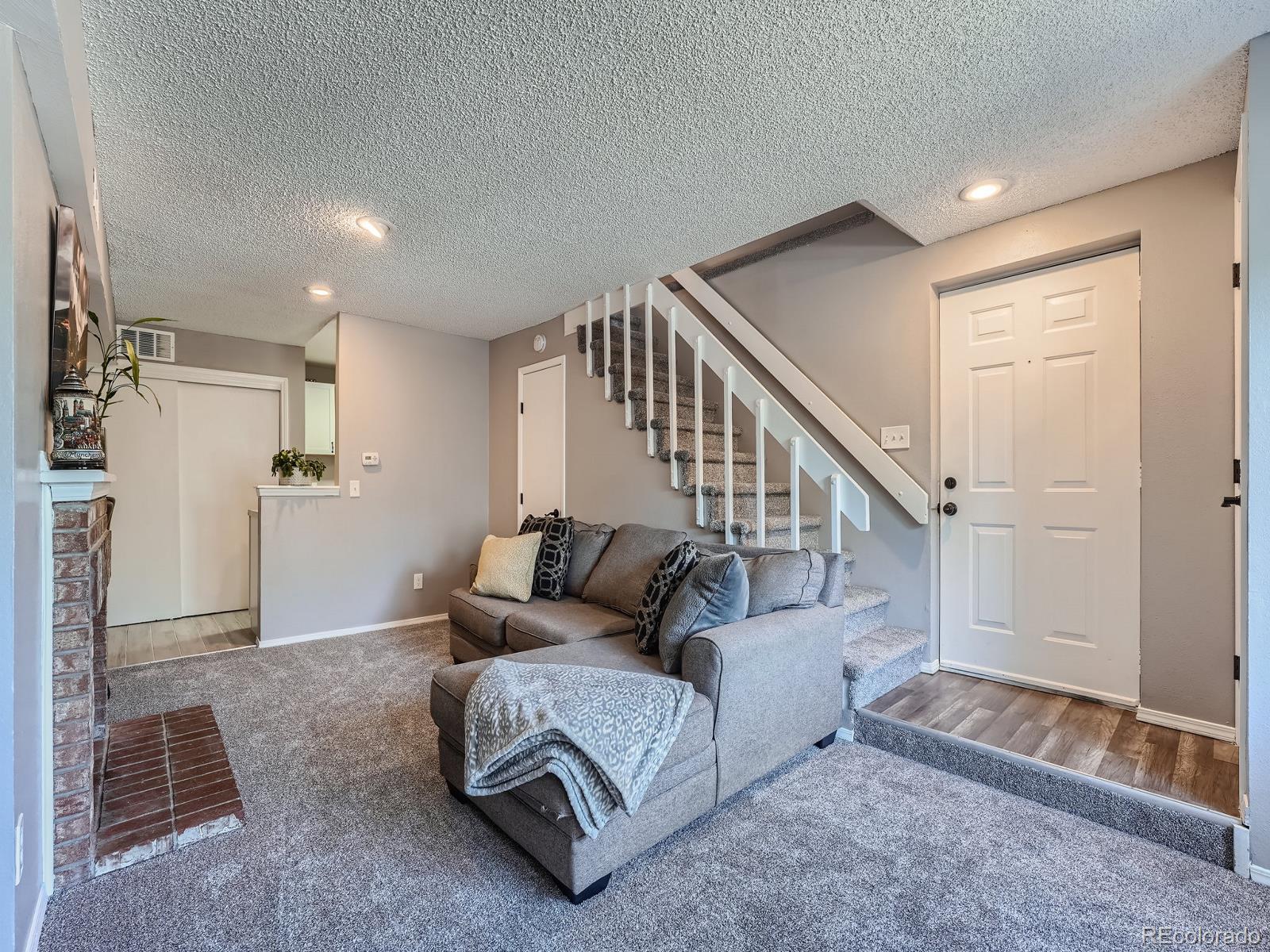 4911 Garrison Street, Unit 202G Wheat Ridge, CO 80033 - Photo 5 of 33 a living room with furniture and wooden floor