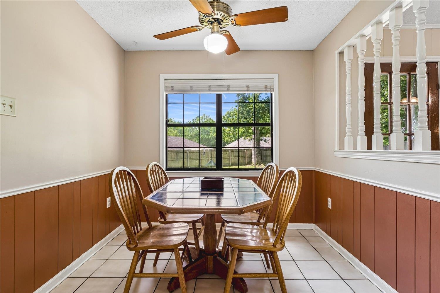 5711 Yale Road Bartlett, TN 38134 - Photo 9 of 29 Dining area featuring a large window, a ceiling fan with integrated lighting, and white tile flooring