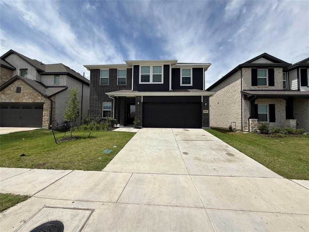 2006 Placerville Street Forney, TX 75126 - Photo 2 of 35 Two-story residence featuring a dark brick and blue siding facade with a two-car garage