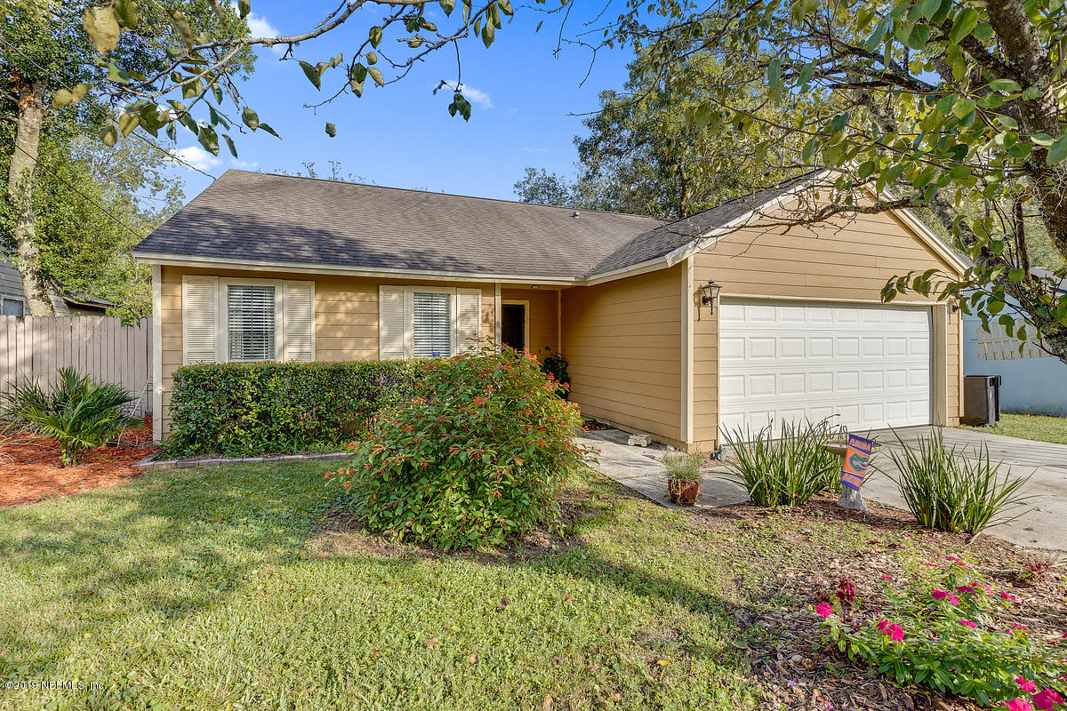 12819 Beaubien Road Jacksonville, FL 32258 - Photo 1 of 17 a front view of a house with garden