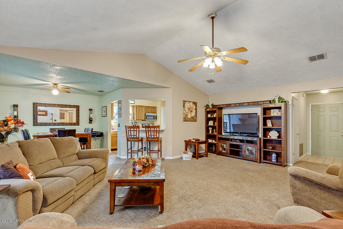 12819 Beaubien Road Jacksonville, FL 32258 - Photo 3 of 17 a living room with furniture and a flat screen tv