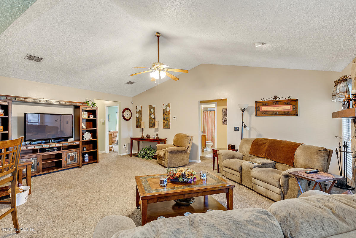12819 Beaubien Road Jacksonville, FL 32258 - Photo 4 of 17 a living room with furniture and a flat screen tv