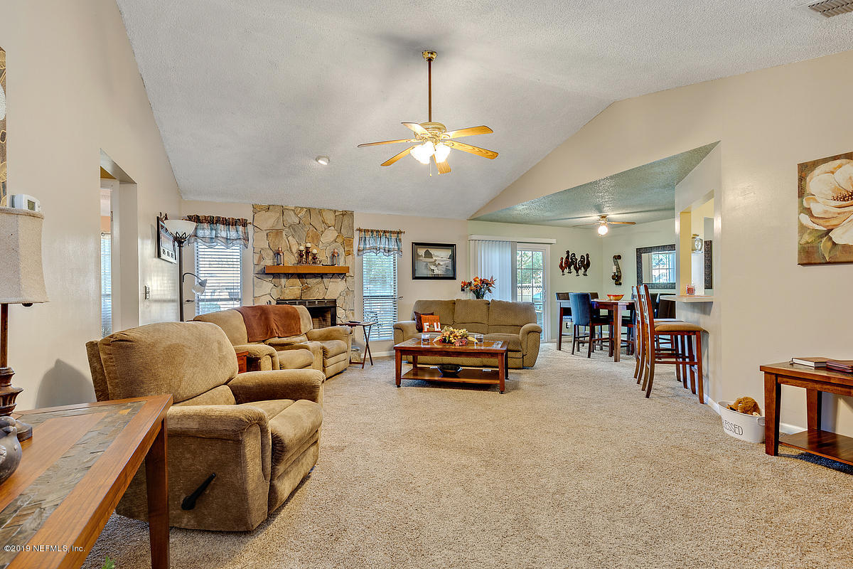 12819 Beaubien Road Jacksonville, FL 32258 - Photo 5 of 17 a living room with furniture a ceiling fan and a window