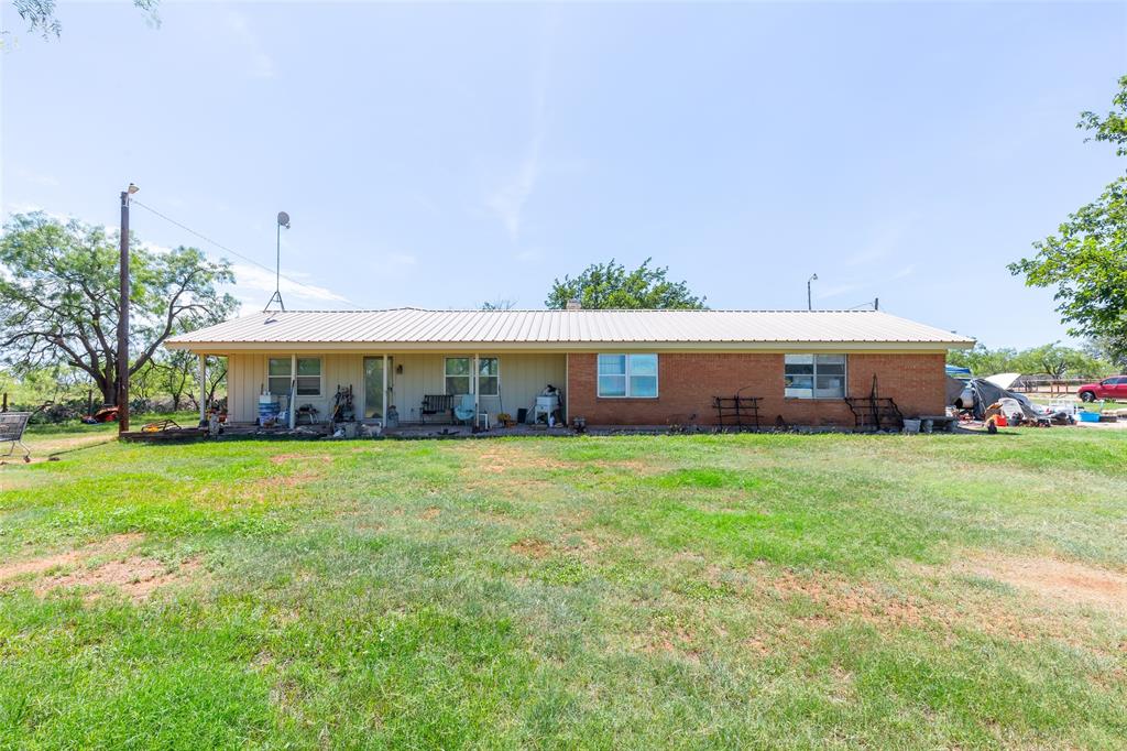 6702 West Lake Road Abilene, TX 79601 - Photo 4 of 21 a front view of a house with a yard and a garage