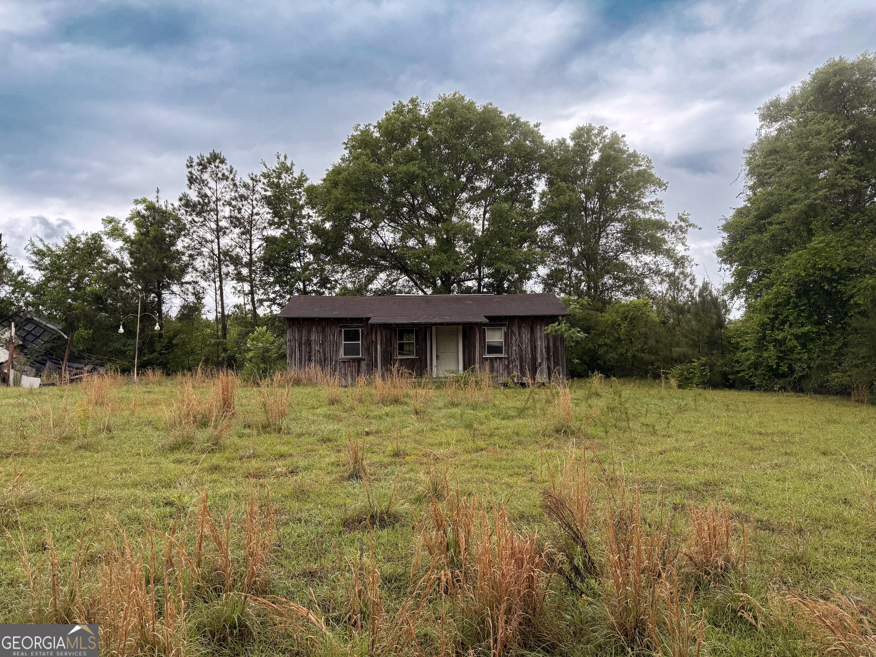 3925 Highway 441 Rentz, GA 31075 - Photo 1 of 16 a backyard of a house with lots of green space