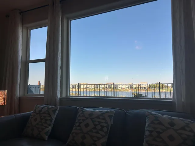 a living room with furniture and a floor to ceiling window