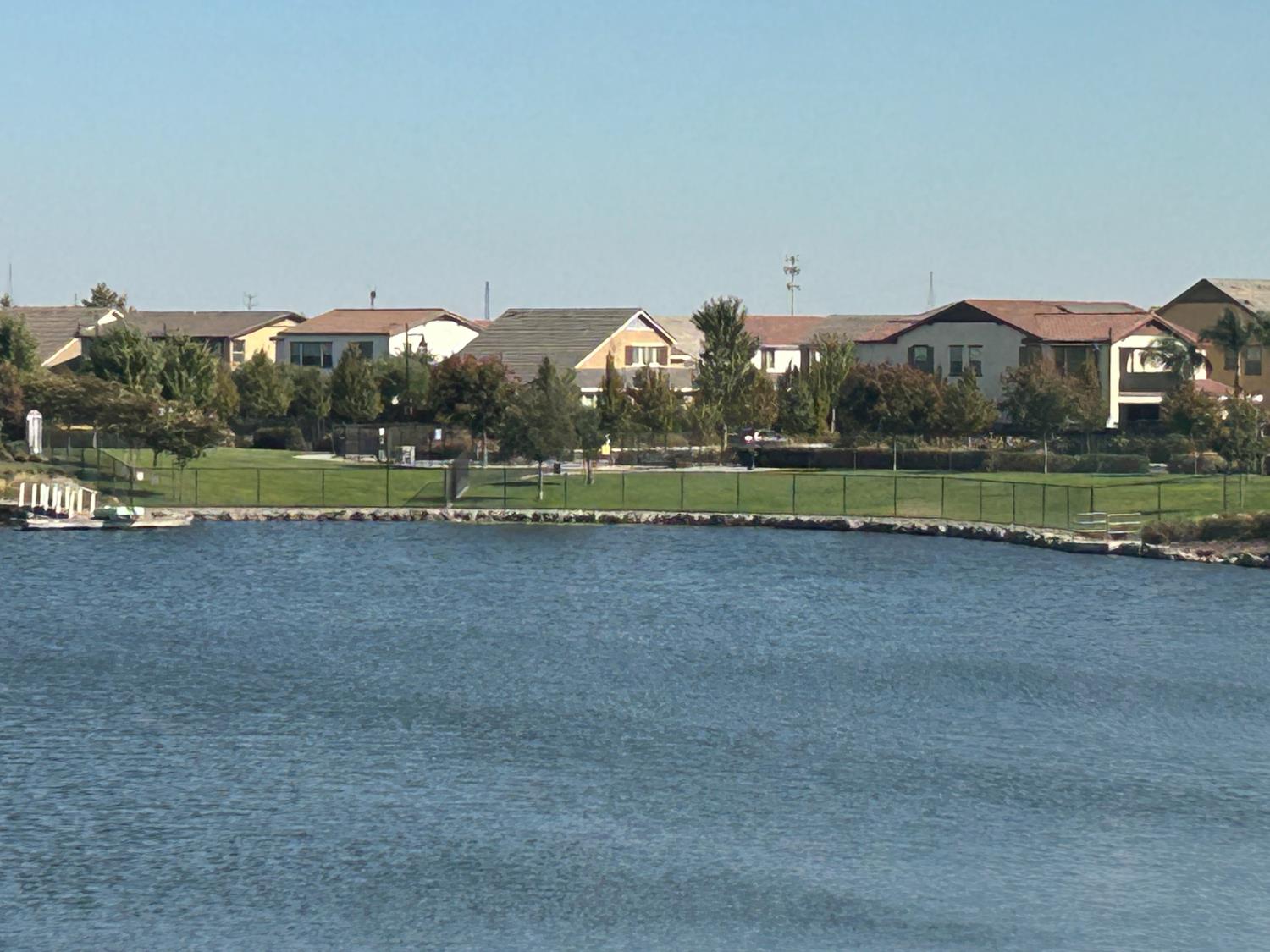 18006 Silver Springs Way Lathrop, CA 95330 - Photo 17 of 26 a view of a green field with an house in the background