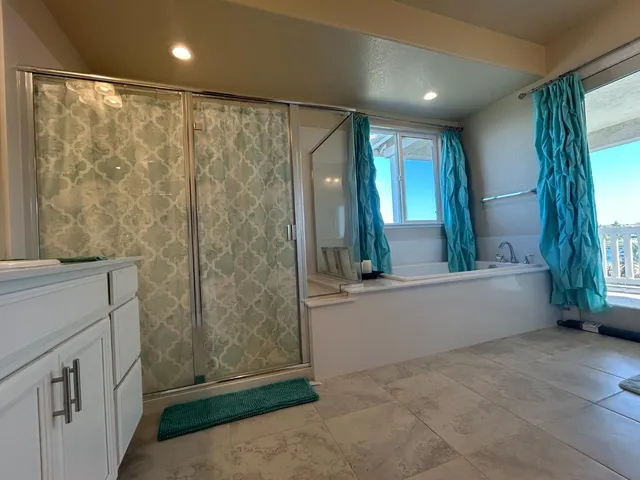 a bathroom with a bathtub and a shower