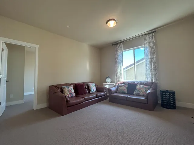 a living room with a couch and a window