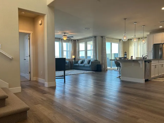 a view of a living room kitchen and a wooden floor
