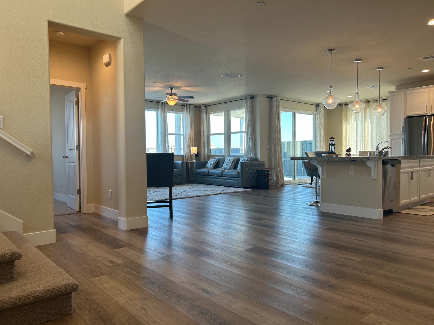 18006 Silver Springs Way Lathrop, CA 95330 - Photo 5 of 26 a view of a living room kitchen and a wooden floor