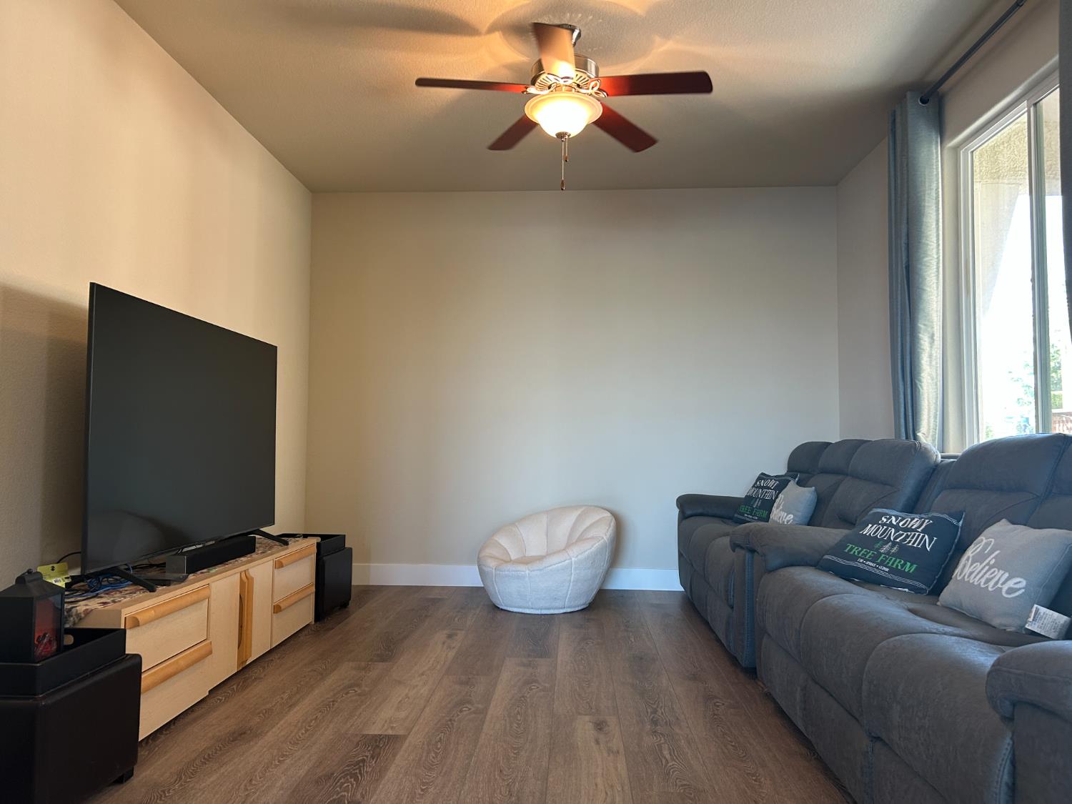 18006 Silver Springs Way Lathrop, CA 95330 - Photo 7 of 26 a living room with furniture and a flat screen tv