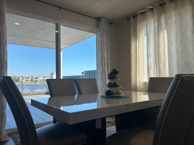 a view of a dining room with furniture and window