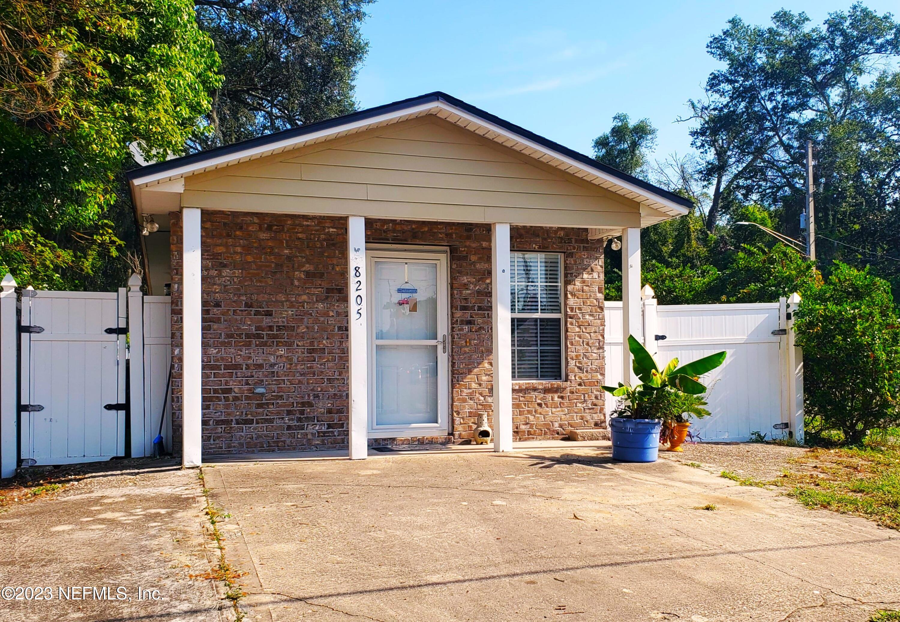 8205 Firetower Road Jacksonville, FL 32210 - Photo 2 of 11 a front view of a house with a yard and garage