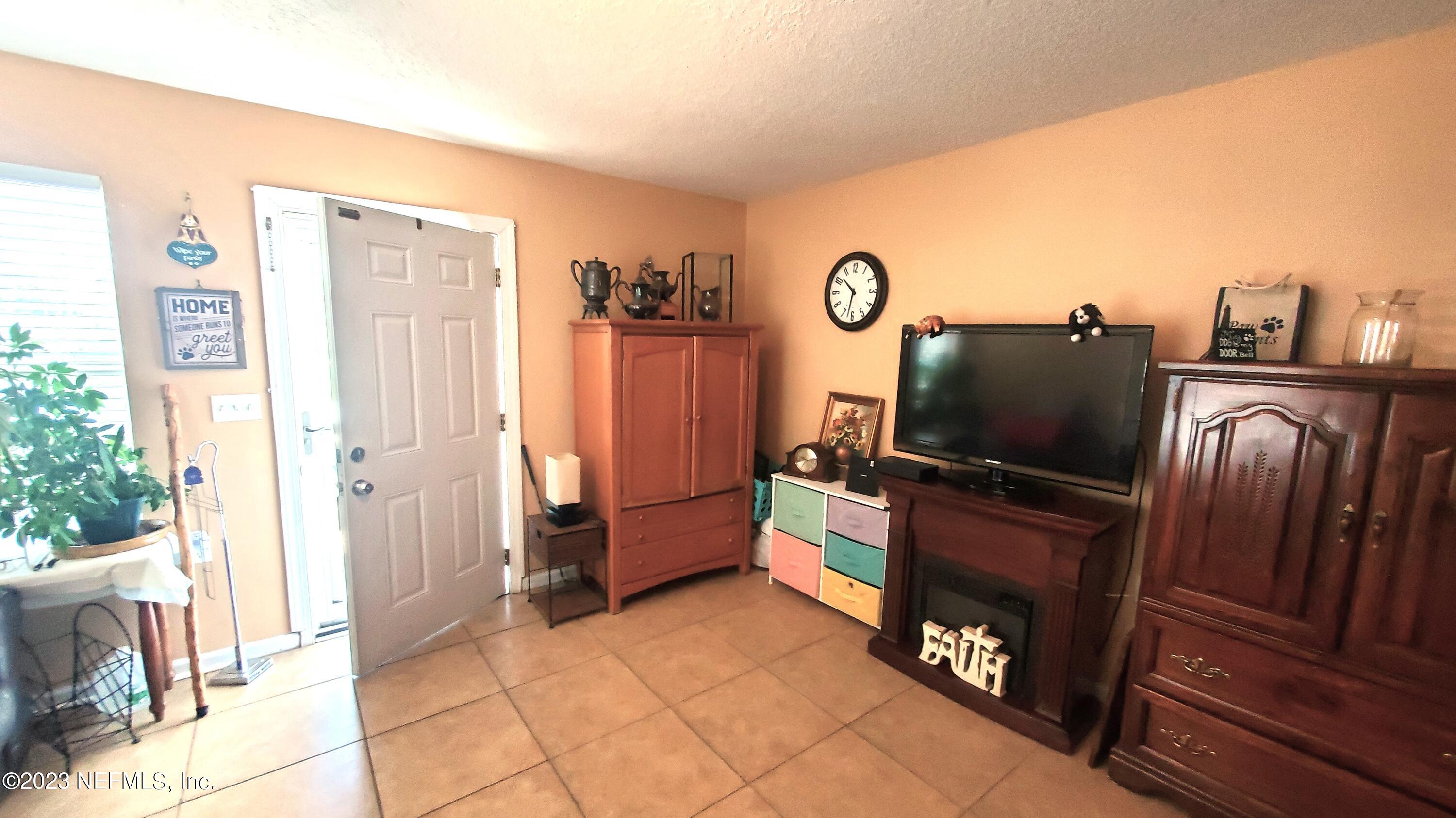 8205 Firetower Road Jacksonville, FL 32210 - Photo 4 of 11 a living room with furniture and a flat screen tv