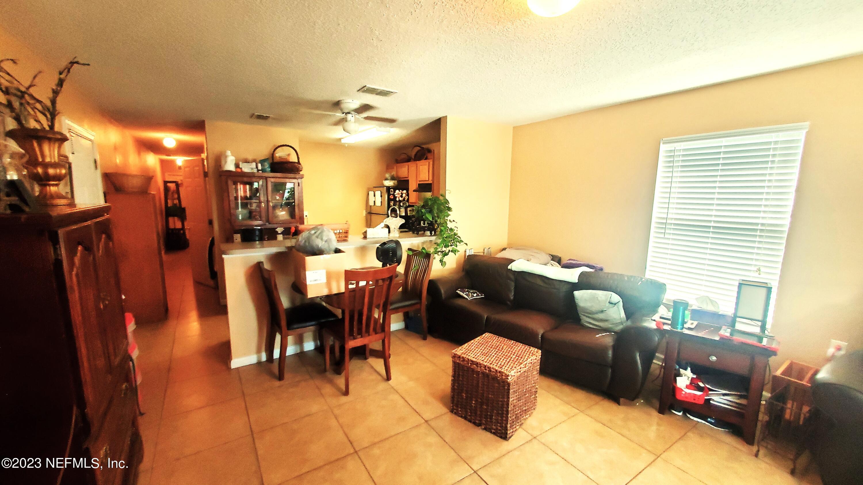 8205 Firetower Road Jacksonville, FL 32210 - Photo 5 of 11 a living room with furniture fireplace and a window