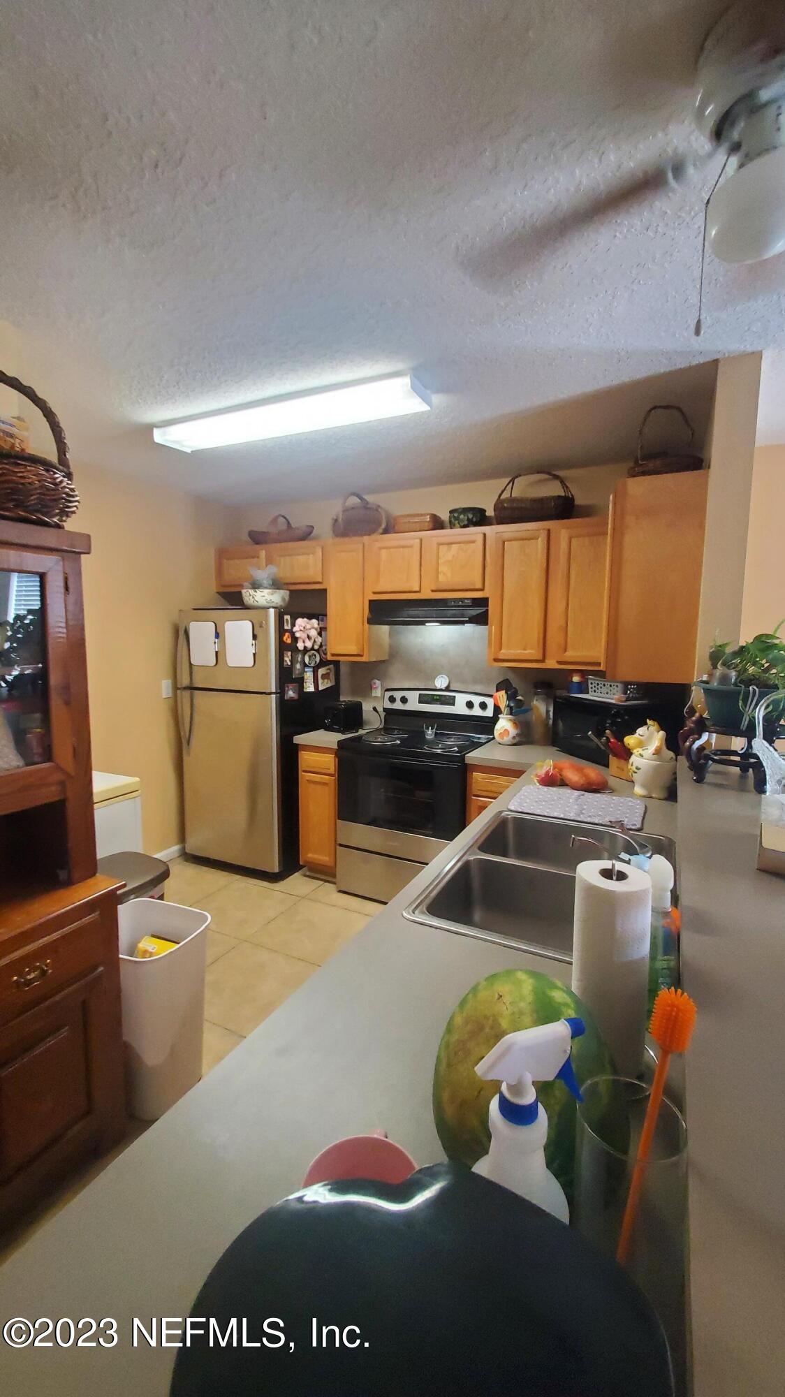8205 Firetower Road Jacksonville, FL 32210 - Photo 6 of 11 a kitchen with stainless steel appliances granite countertop a sink stove and refrigerator