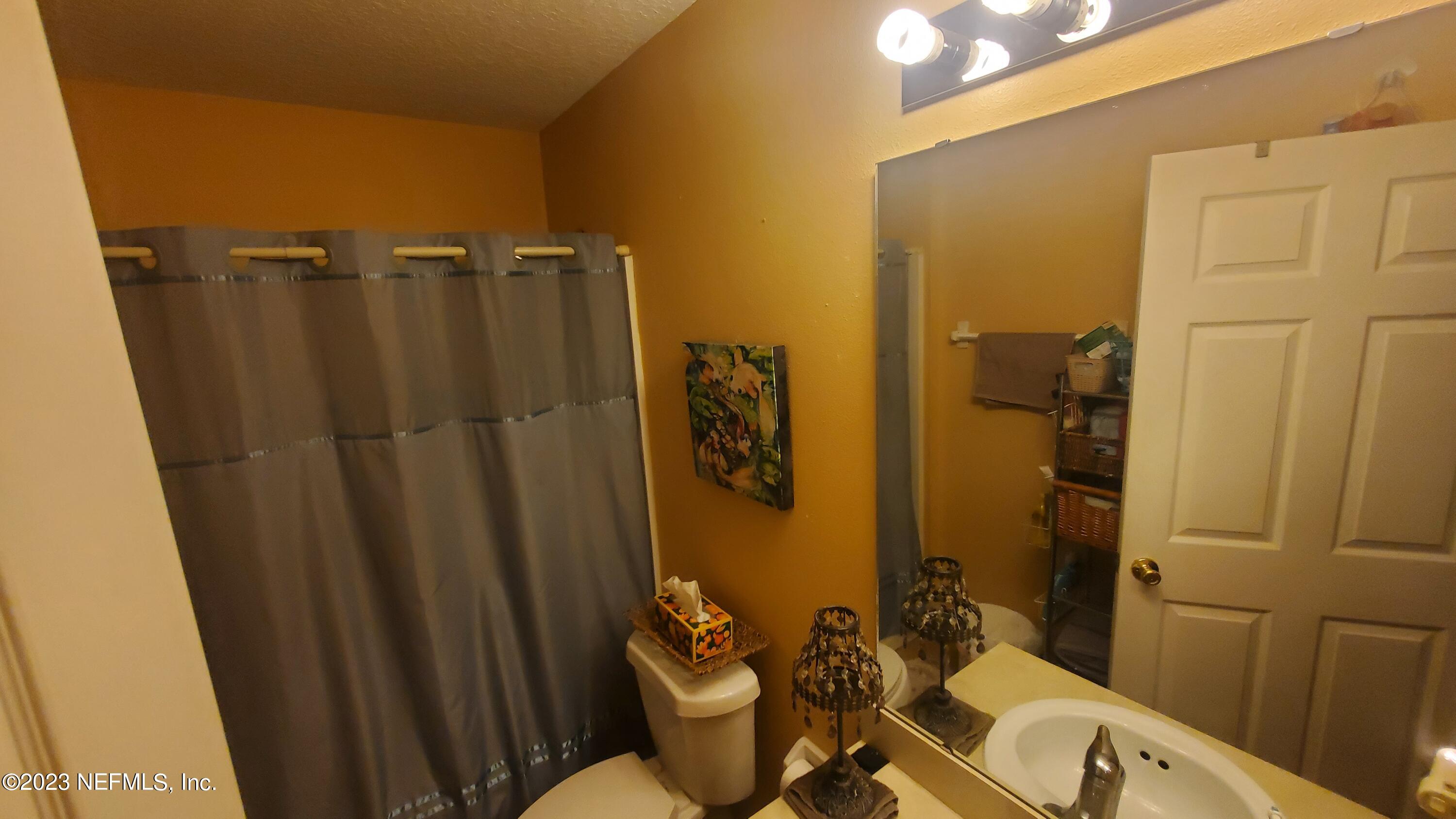 8205 Firetower Road Jacksonville, FL 32210 - Photo 8 of 11 a bathroom with a sink and toilet