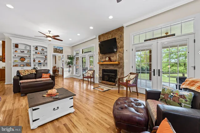 a kitchen with stainless steel appliances granite countertop a stove top oven a sink dishwasher and cabinets with wooden floor