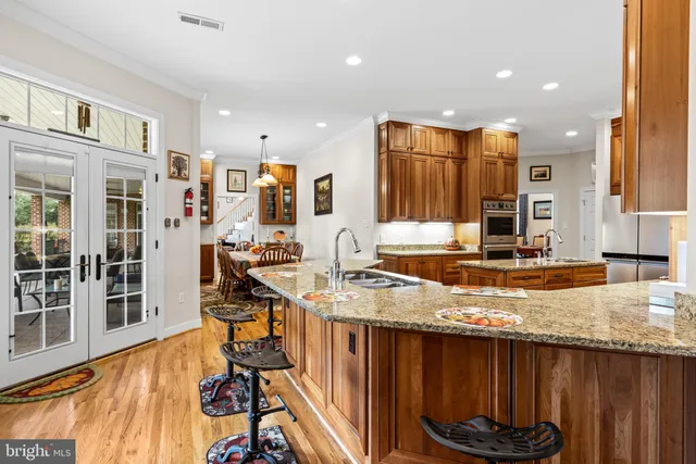 a kitchen with stainless steel appliances granite countertop a stove a sink and a microwave