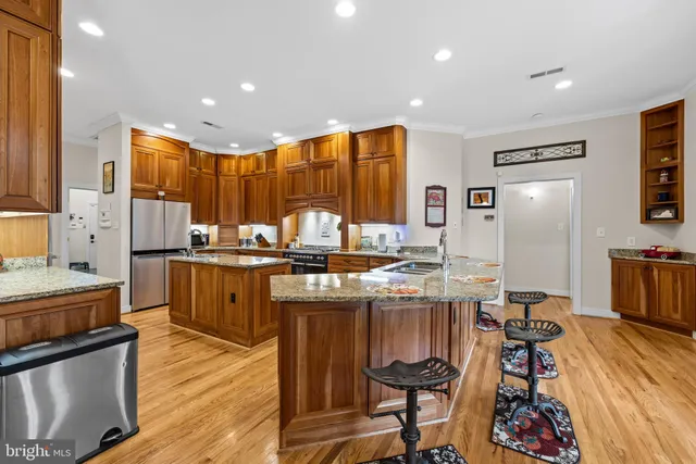 a view of a dining room with furniture a chandelier and wooden floor