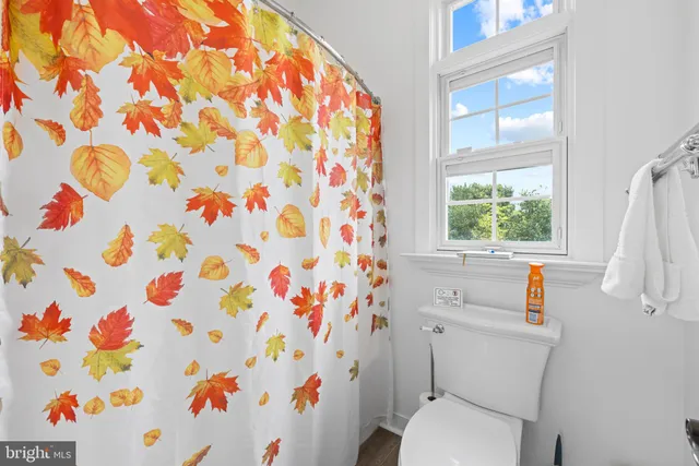a bathroom with a sink a vanity and a large mirror