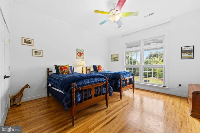 a living room with furniture a dining table and chairs with wooden floor