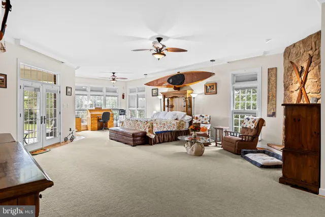 a bedroom with a bed chair and window