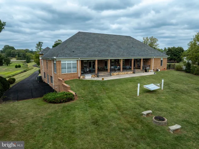 a view of a patio with chairs and floor to ceiling window