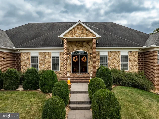 a view of a living room with furniture and a wooden floor