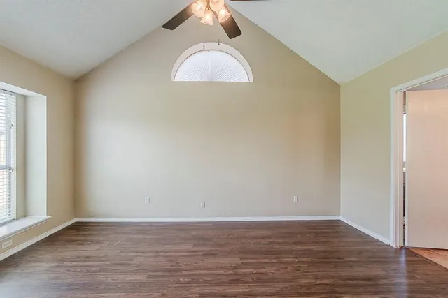 a view of a room with wooden floor and white walls