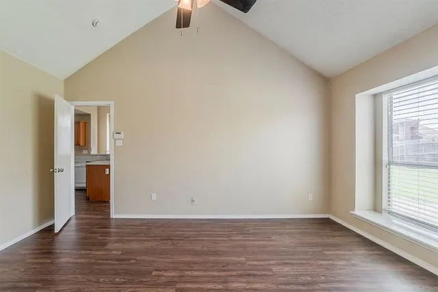 a view of a livingroom with wooden floor and a window