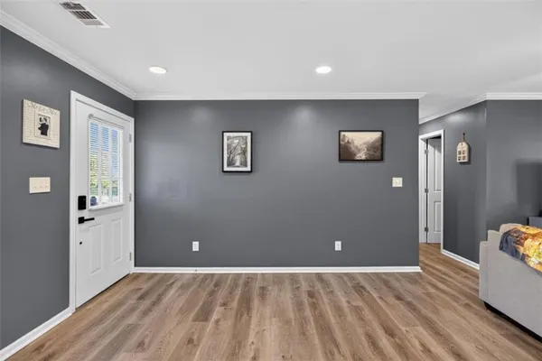 a view of a livingroom with wooden floor and closet