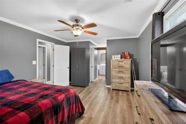 a bedroom with a bed and a chandelier